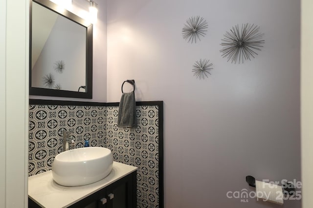 bathroom featuring decorative backsplash and vanity