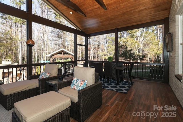 sunroom / solarium featuring wooden ceiling, lofted ceiling, and plenty of natural light