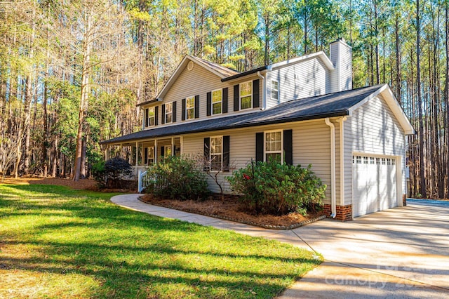 view of front of property with a front yard, a porch, and a garage