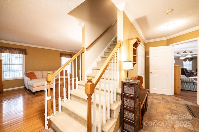 stairs with crown molding and hardwood / wood-style flooring