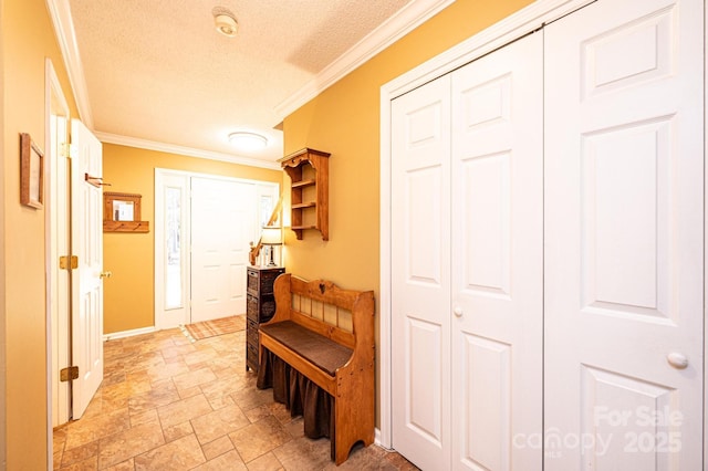 corridor with a textured ceiling and ornamental molding