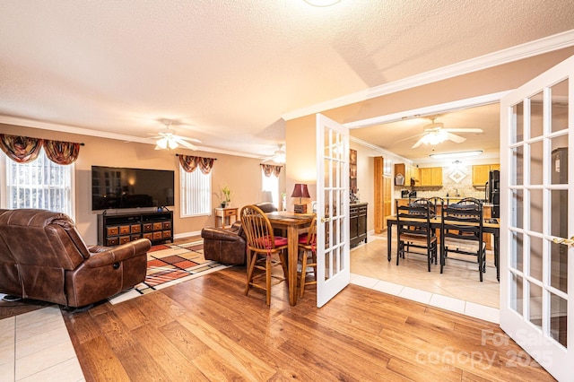 living room with a textured ceiling, hardwood / wood-style flooring, and french doors