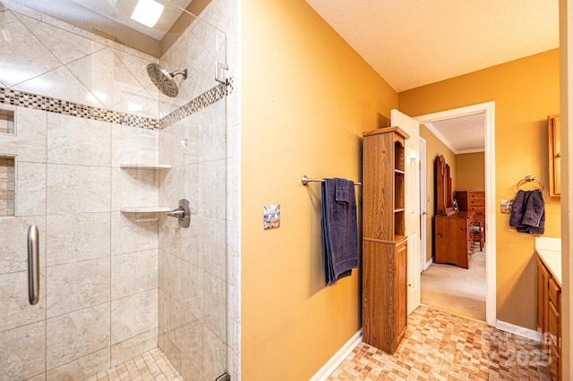 bathroom featuring a textured ceiling, a shower with door, crown molding, and vanity