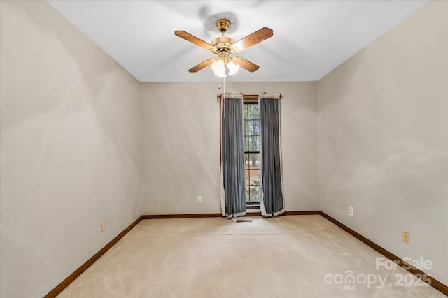 carpeted empty room featuring ceiling fan