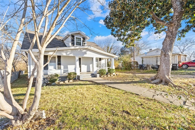 bungalow-style house featuring a front lawn and covered porch