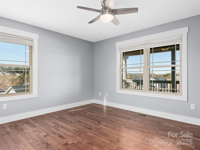 unfurnished room featuring ceiling fan, a healthy amount of sunlight, and hardwood / wood-style flooring