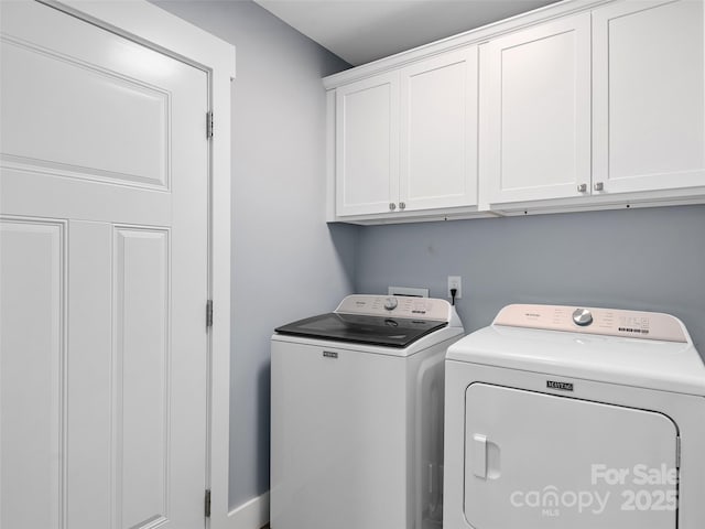 washroom featuring washer and clothes dryer and cabinets