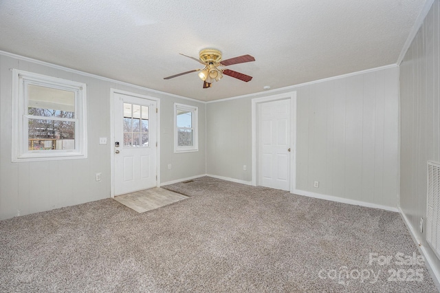 interior space with crown molding, carpet floors, and a textured ceiling