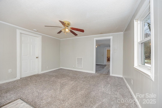 unfurnished room with ceiling fan, crown molding, a textured ceiling, and carpet