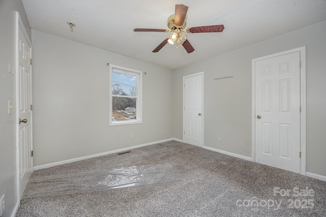 unfurnished bedroom with carpet floors, a textured ceiling, and ceiling fan