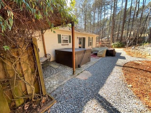 exterior space featuring a hot tub and a patio area