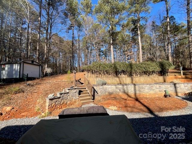 view of yard with a garage and an outbuilding