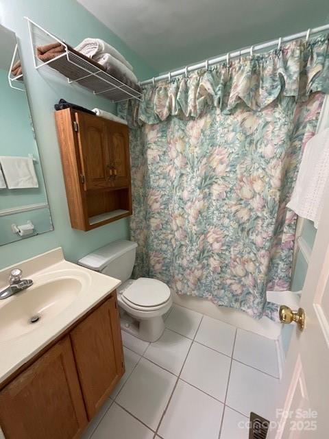 bathroom with vanity, tile patterned floors, and toilet