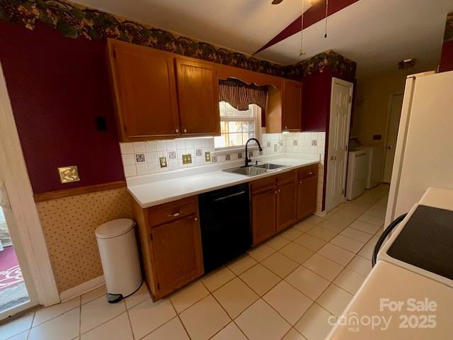 kitchen featuring white appliances, washer / clothes dryer, sink, and backsplash