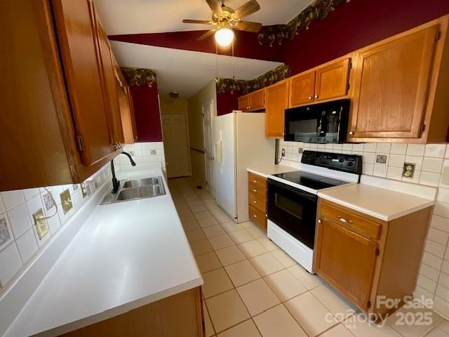 kitchen featuring sink, decorative backsplash, white refrigerator with ice dispenser, light tile patterned floors, and electric range