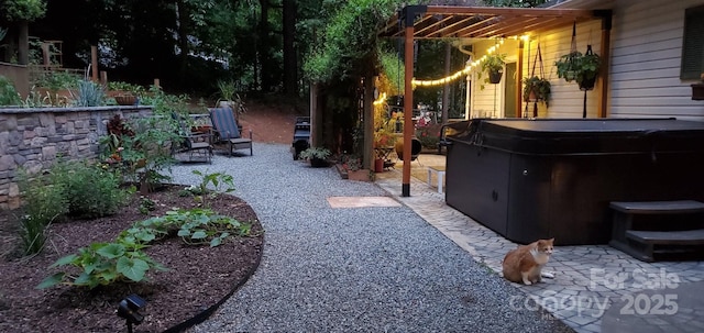 view of yard featuring a hot tub and a patio