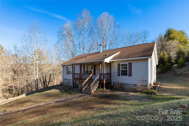 ranch-style home featuring a front yard and a porch