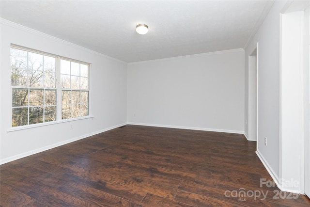 empty room with dark wood-type flooring and ornamental molding