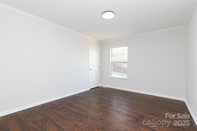 empty room with crown molding and dark hardwood / wood-style flooring