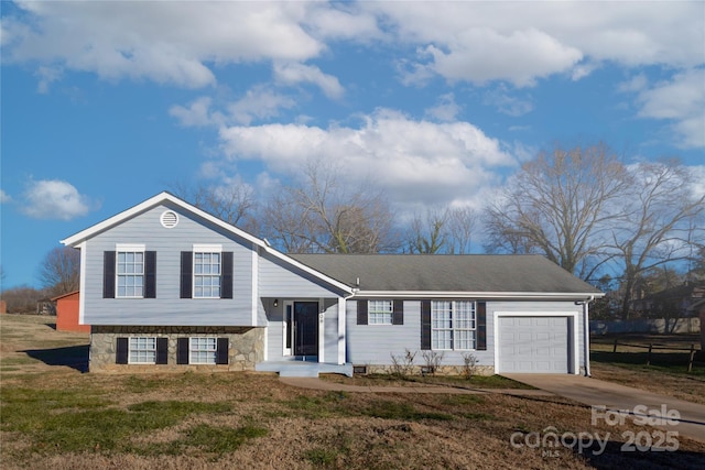 split level home with a front lawn and a garage