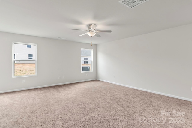 carpeted spare room with ceiling fan