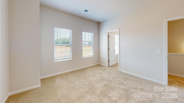 unfurnished room featuring light carpet