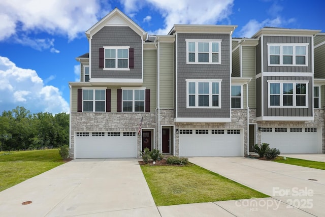 multi unit property featuring a front yard and a garage