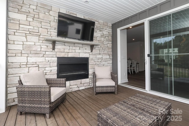 wooden terrace featuring a fireplace