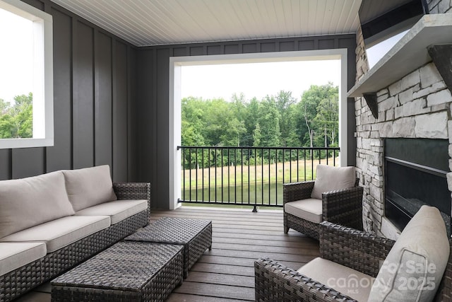 exterior space featuring an outdoor stone fireplace and hardwood / wood-style floors