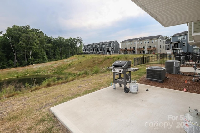 view of patio / terrace featuring a grill and central AC unit