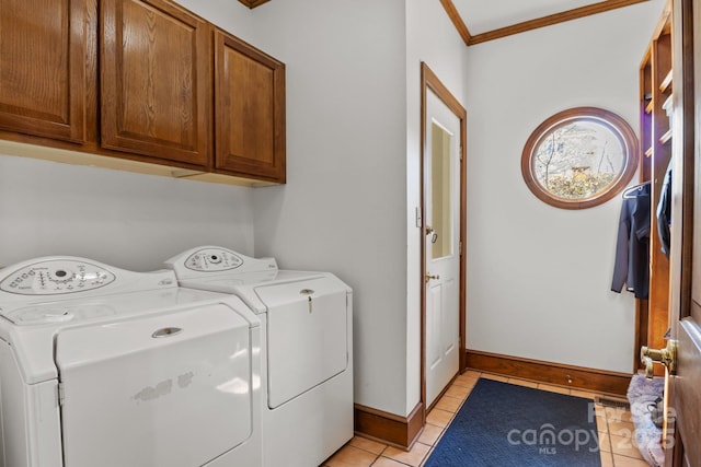 laundry room with light tile patterned floors, baseboards, separate washer and dryer, cabinet space, and ornamental molding