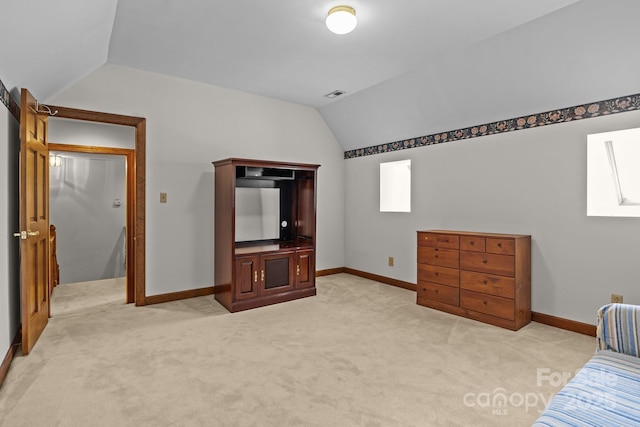 bedroom featuring visible vents, light colored carpet, baseboards, and vaulted ceiling