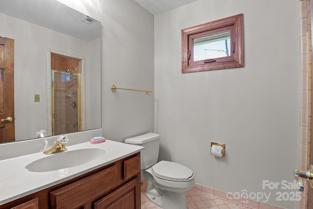 bathroom featuring tile patterned flooring, visible vents, a shower stall, toilet, and vanity