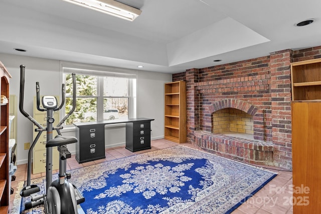 workout room with tile patterned flooring, a fireplace, and baseboards