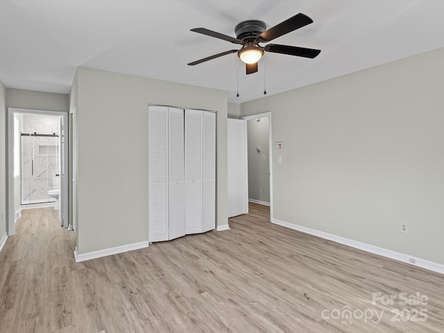 unfurnished bedroom featuring ceiling fan, a closet, and light wood-type flooring