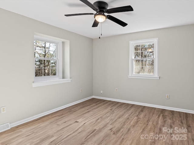 spare room featuring ceiling fan and light hardwood / wood-style flooring