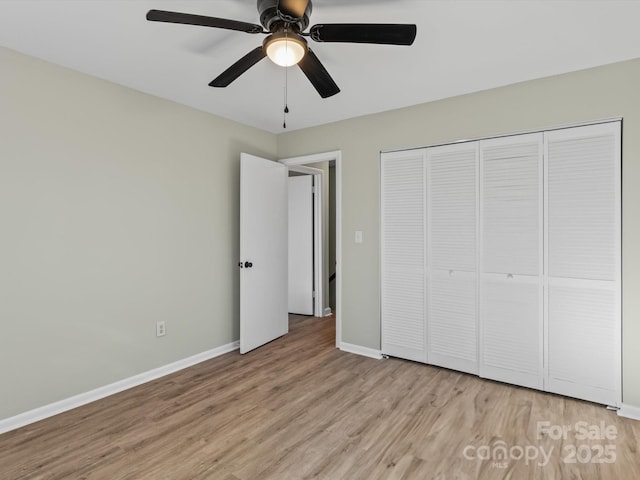 unfurnished bedroom featuring ceiling fan, a closet, and light hardwood / wood-style flooring