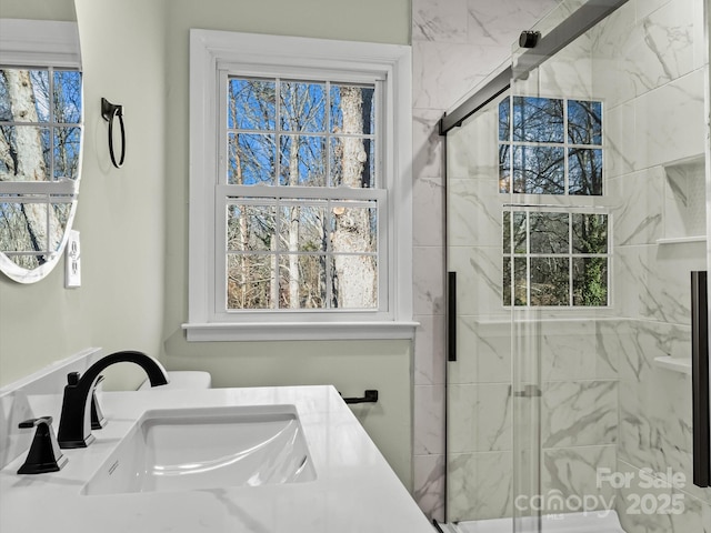 bathroom featuring walk in shower and vanity