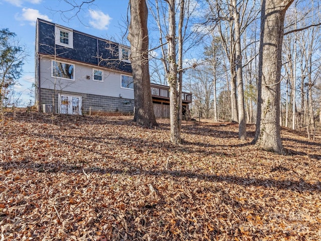 back of property featuring a wooden deck