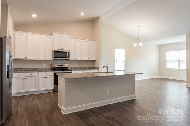 kitchen with an island with sink, stainless steel appliances, hanging light fixtures, white cabinets, and sink