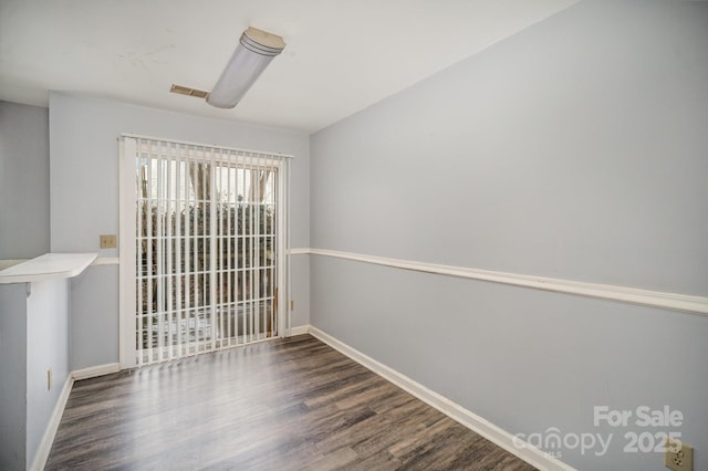 unfurnished room featuring dark hardwood / wood-style floors