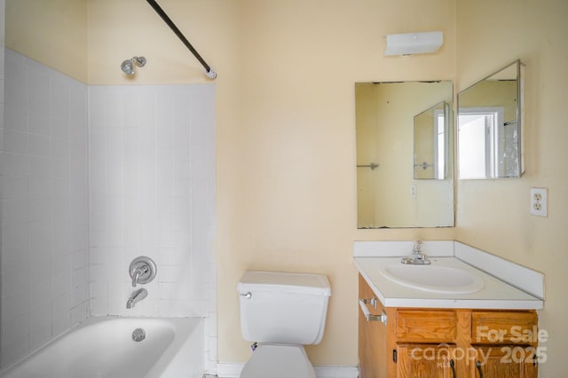 full bathroom with tiled shower / bath, vanity, and toilet