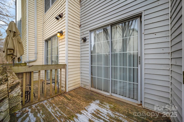 view of exterior entry with a deck