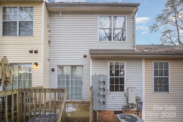 back of house featuring a wooden deck and central air condition unit