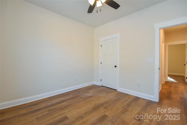 unfurnished bedroom with ceiling fan and wood-type flooring