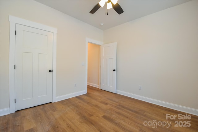 unfurnished bedroom with ceiling fan and hardwood / wood-style floors