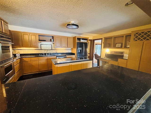 kitchen with backsplash, sink, a center island, and appliances with stainless steel finishes