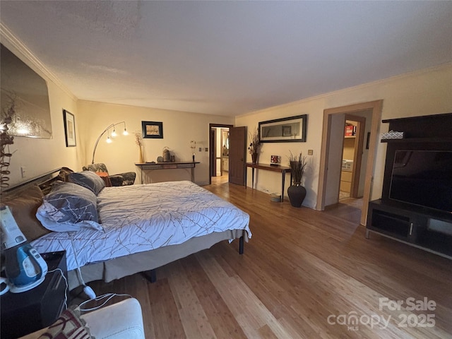 bedroom with hardwood / wood-style flooring and ornamental molding