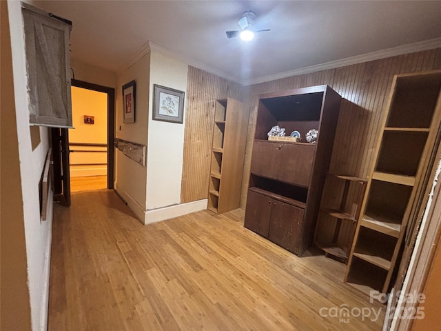 interior space featuring crown molding and light hardwood / wood-style floors