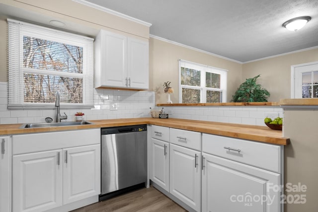 kitchen with white cabinetry, butcher block countertops, and stainless steel dishwasher